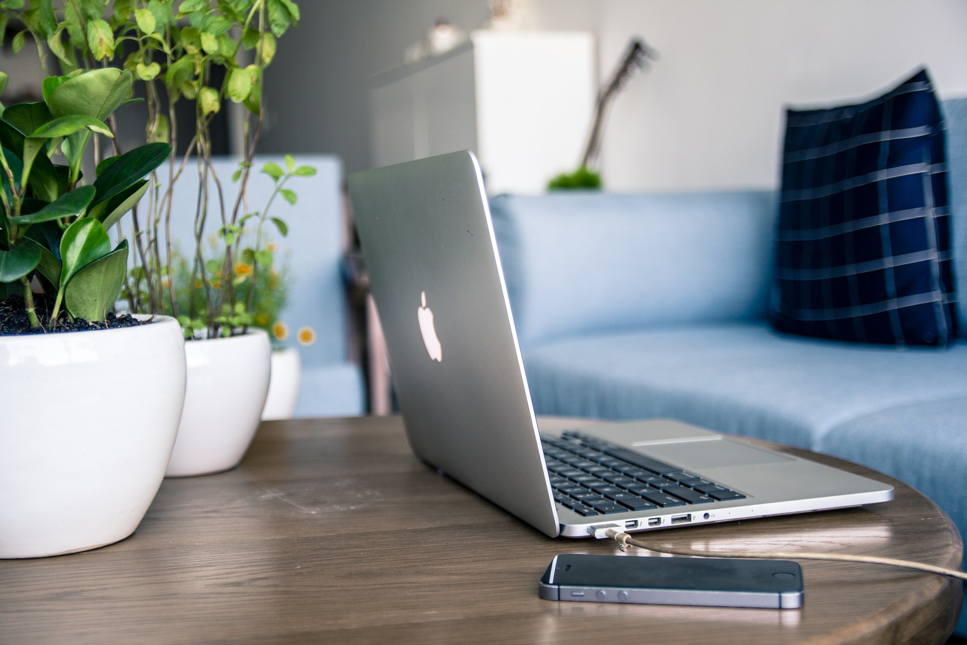 Macbook and phone sitting on a table| Purely Write